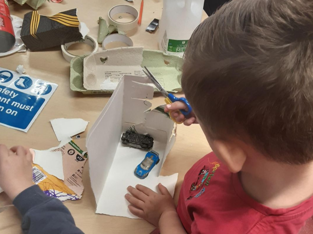Child in nursery playing with arts and crafts